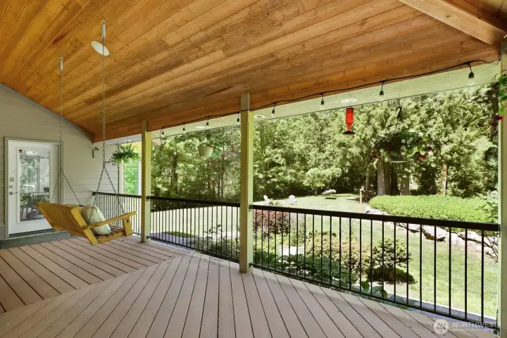 Wrap around porch with lots of space to enjoy views of the private yard Wrap around porch with lots of space to enjoy views of the private yard