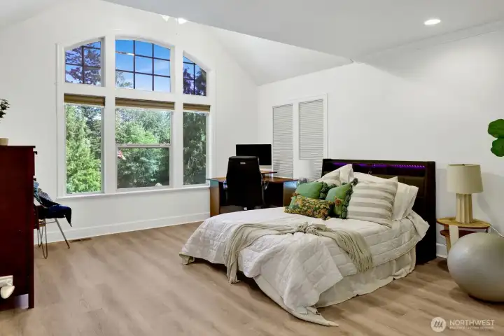 Secondary bedroom #1 features vaulted ceilings and a dramatic window Secondary bedroom #1 features vaulted ceilings and a dramatic window