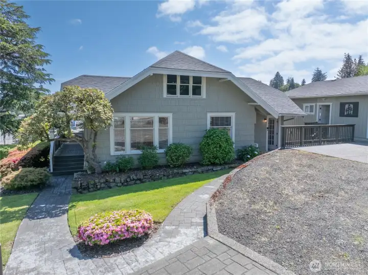 Paved path from the driveway to the front porch or no stairs at the back door entrance. Paved path from the driveway to the front porch or no stairs at the back door entrance.
