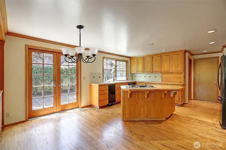 Opne concept kitchen featuring hardwood floors and oak cabinetry Opne concept kitchen featuring hardwood floors and oak cabinetry