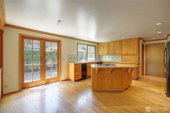 Open concept kitchen featuring hardwood floors and beautiful oak cabintry