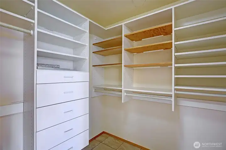 Walk in closet with tons of hanging space, shelves, shoe storage and drawers