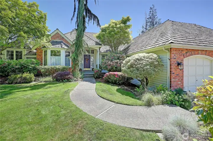 Front of the home with mature landscaping