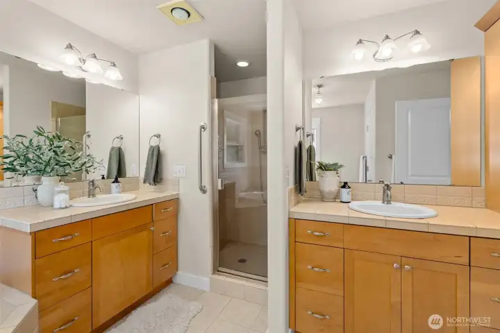Primary bathroom with dual vanities, large soaking tub, separate shower and water closet