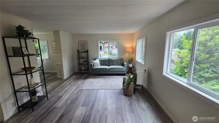 New windows in the living room with new vinyl plank flooring throughout