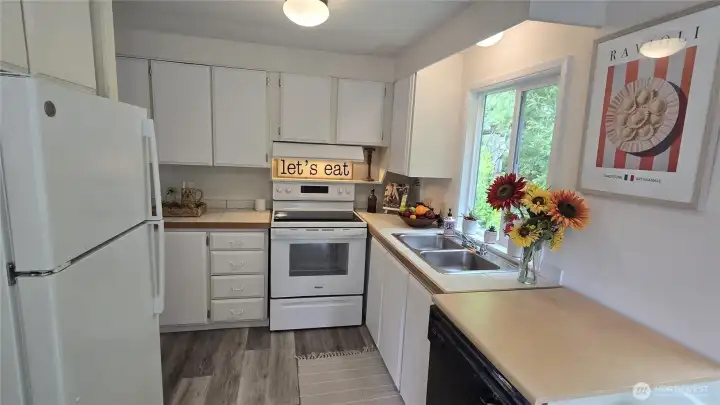 Clean, efficient kitchen with new appliances and windows