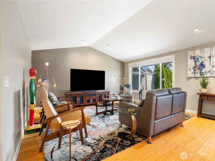The liiving room with its vaulted ceilings and abundance of natural light is bright and welcoming.