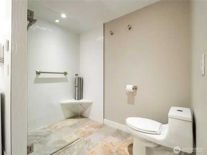 The sleek walk in shower is easy to clean and use.