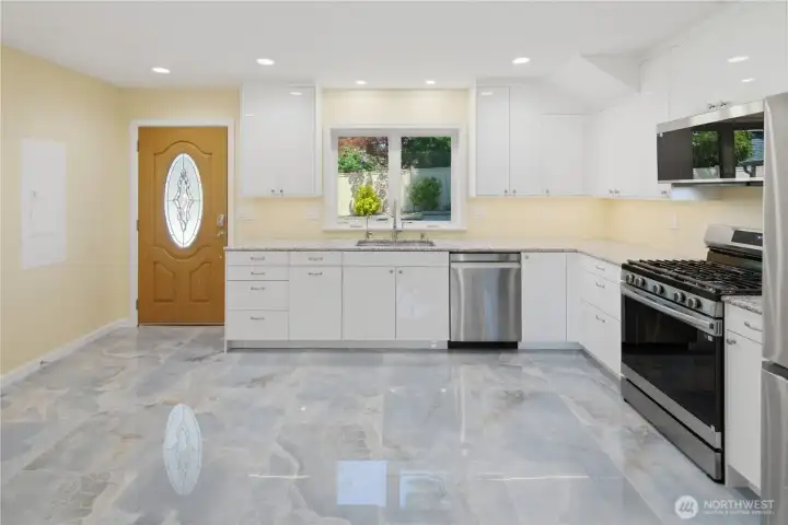 Porcelain tile accentuates the glossy cabinets.