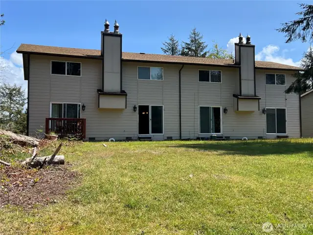 4 unit townhomes overlooking a nice grassy back yard. Unit B is the second one from the left.