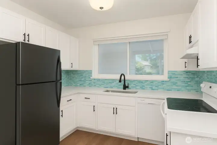 Virtually staged kitchen with current floors and appliances.