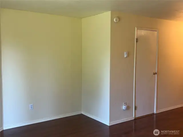 Living room leads to the entry hallway and the 1/2 bath behind the door.