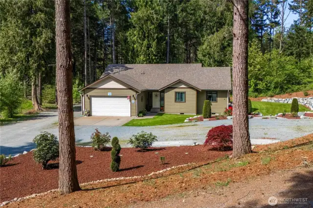 Mature evergreens surround this peaceful property.
