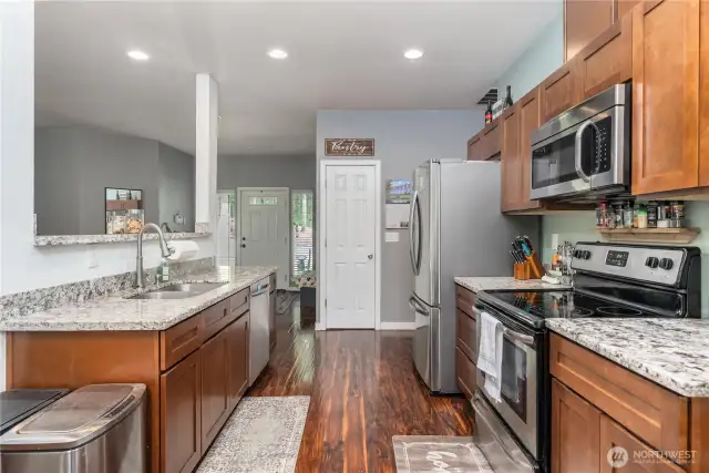 Kitchen with granite counters and stainless appliances.