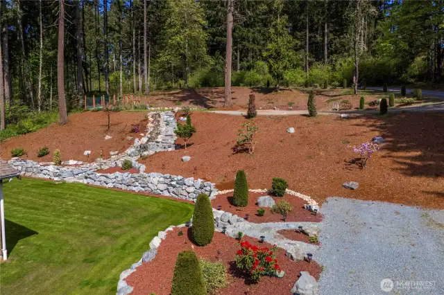 Terreced yard with waterfall and garden space.