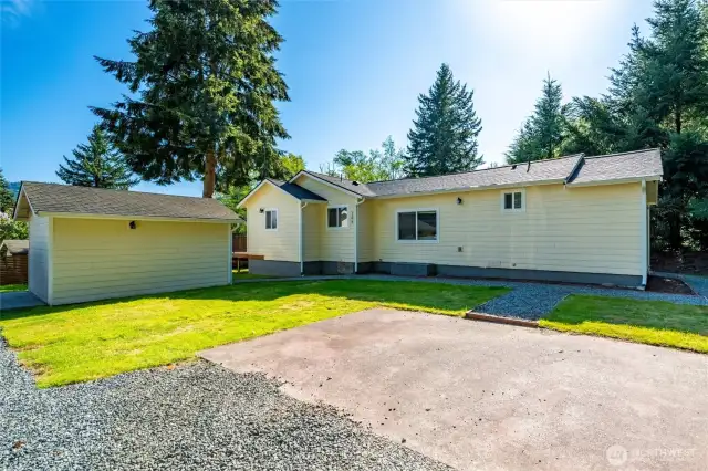 As you pull up to the home, you will find two concrete parking spaces and a medium-sized shop with a walkway to the front door.