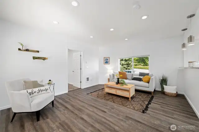 Looking across the living room with the primary suite beyond.