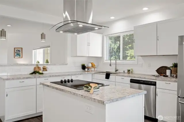 The island has an electric range and a sleek exhaust hood.