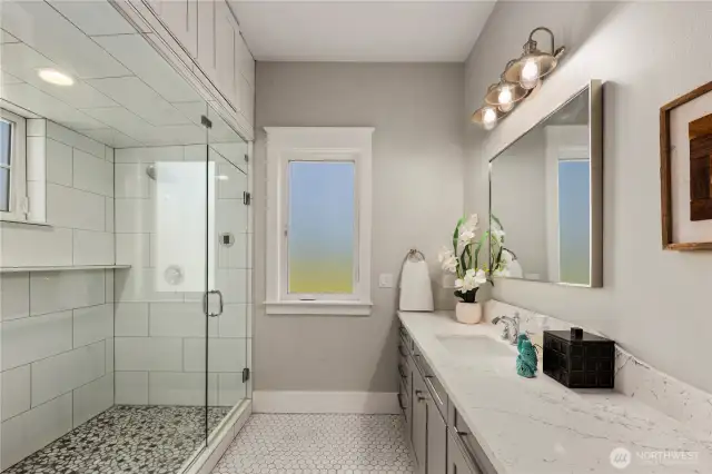 Steam shower and one of two separated vanaties.
