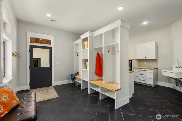 Expansive mud/laundry room with slate flooring. One of two laundry rooms - second laundry room located upstairs!