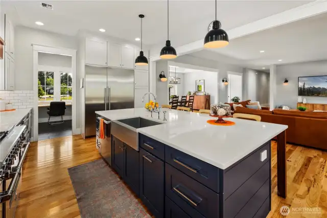 Wide angel view of the kitchen, pantry, living and dining areas.