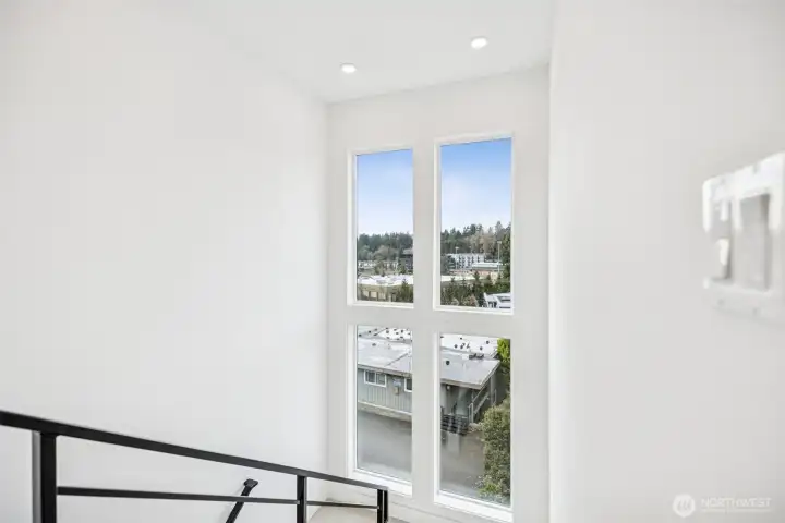 Landing with four  large windows with expansive views of sunsets, territorial and partial downtown.