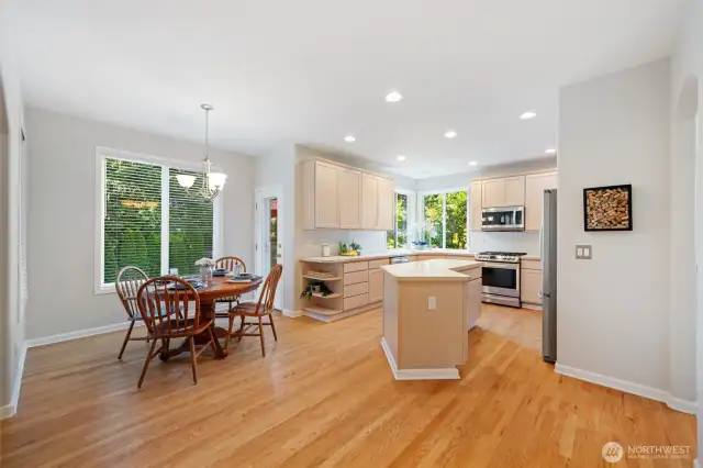 From the informal living area looking into the kitchen. Large island, massive light, lots of work space. eating dinette area is just to the left and the door to the deck too.