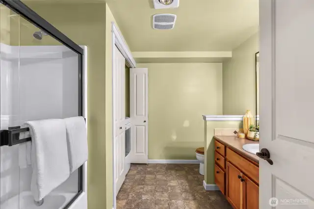 Large bathroom with glass enclosed shower/tub.
