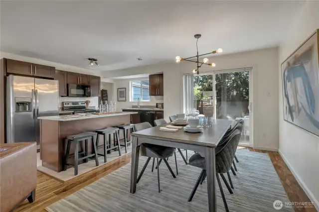 Imagine hosting in this space or enjoying it everyday. The island has so much counter space to prep or set up for breakfast. The dining area overlooks the private backyard.