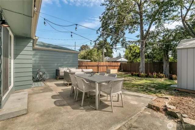 Room for everyone here. This fenced backyard has a great patio ready for your dining and conversation set.