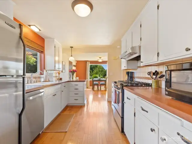 Lovely Kitchen with wood floors, stainless appliances, lots of counters & cabinets, & view window out the front.