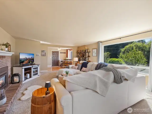 Spacious Living Room with propane Fireplace & walls of view windows.