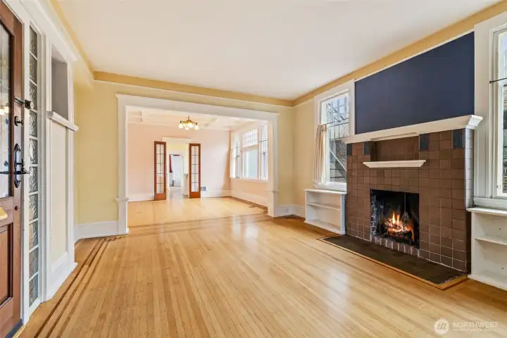 Spacious living room with Art Deco tilework and built-ins framing a cozy fireplace.