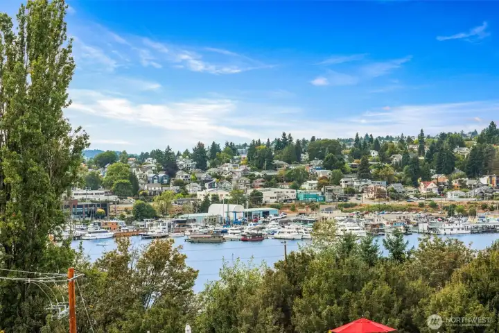Sweeping vistas of Lake Union, floating homes, and the surrounding hillside neighborhood.