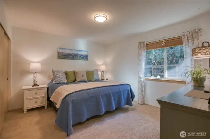 First bedroom overlooking private, serene landscape is large enough to accommodate a king size bed
