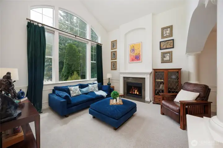 Grand formal living room offers vaulted ceilings and extra large picture windows.