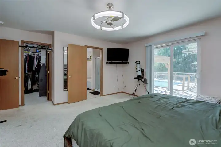 Primary bedroom includes private bathroom, walk in closet, and access to backyard.