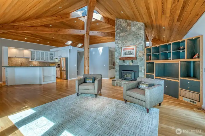 Great room featuring beautiful locally milled timber art piece and glass roof.