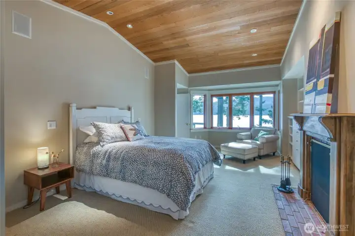 Full view of primary bedroom, sitting area, and fireplace. (queen bed for reference)