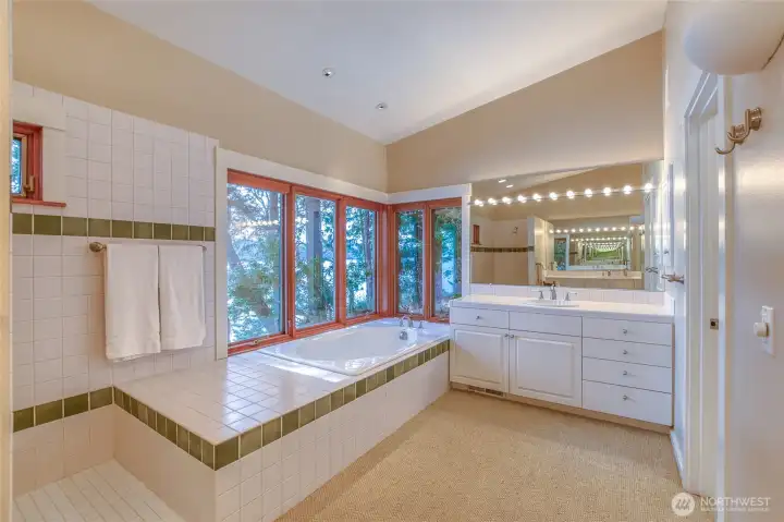 Large double- vanity primary bathroom with soaking tub, walk-in shower, toilet room, and views!