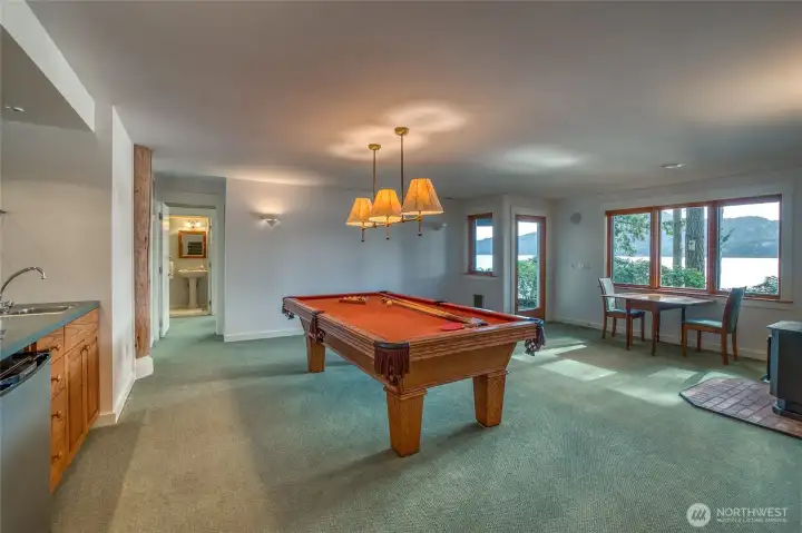 Lower level rec room, built in mini bar, pellet stove, and door to lawn area and to beach.