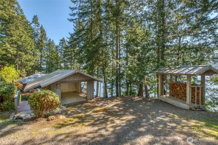 1424 main carport and wood shed, customized shop and second carport up driveway.
