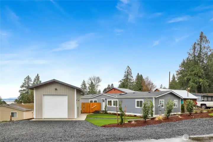 Driveway approach with shop and peekaboo water views