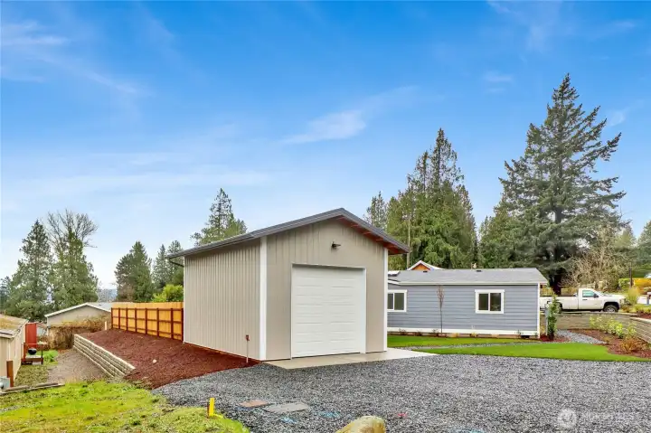 Exterior showing large gravel parking area and shop