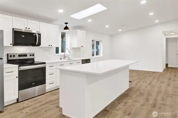 Kitchen with oversized island and quartz counters