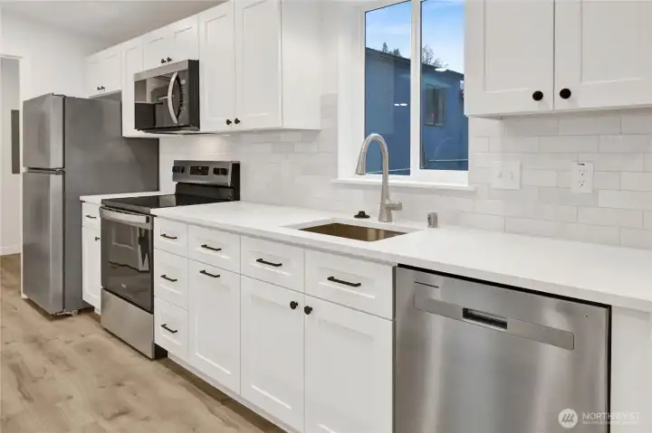 Bright, modern kitchen featuring subway tile backsplash, under-cabinet lighting, and abundant storage.