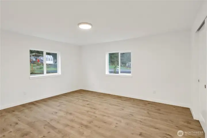 Bright secondary bedroom overlooking the landscaped yard.