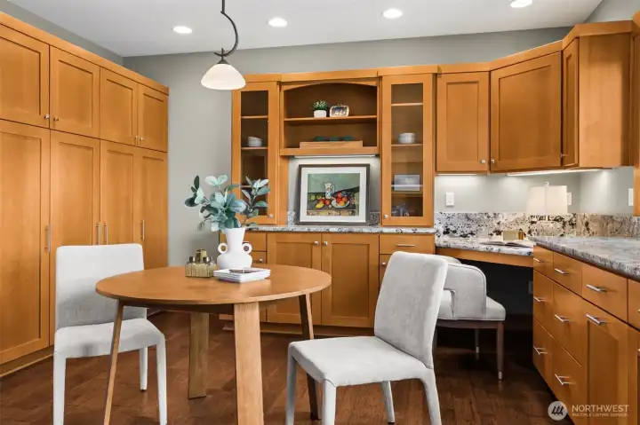 Breakfast nook with built-in buffet/hutch, pull out pantry cabinets, and designated desk area