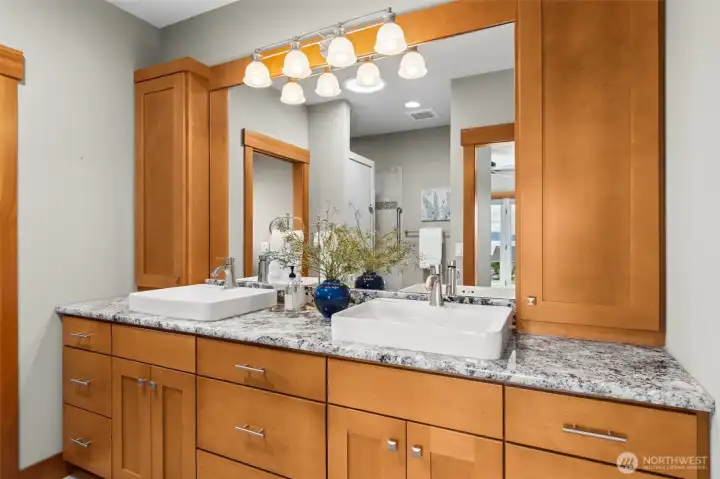 Double sink vanities with lots of storage, separate water closet and heated tile flooring