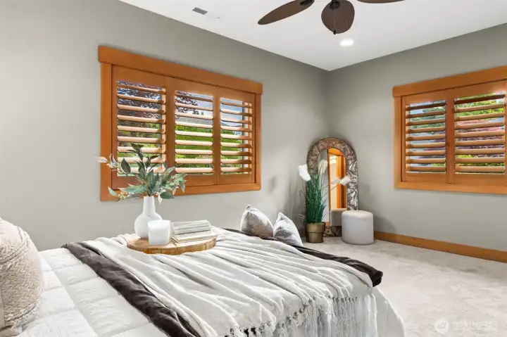 Junior suite with large closet, ceiling fan, full bathroom, and separate exterior entrance through courtyard
